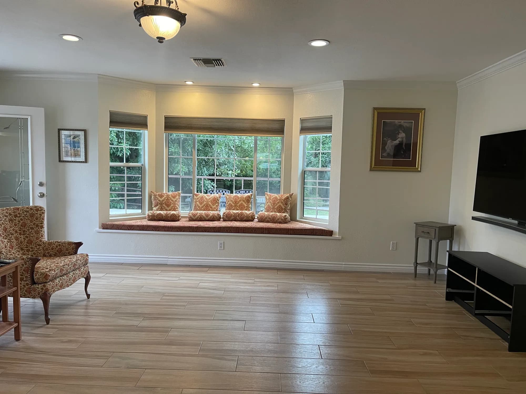 Living room at Bradford Residential Care with a window seat, residential seating, and television